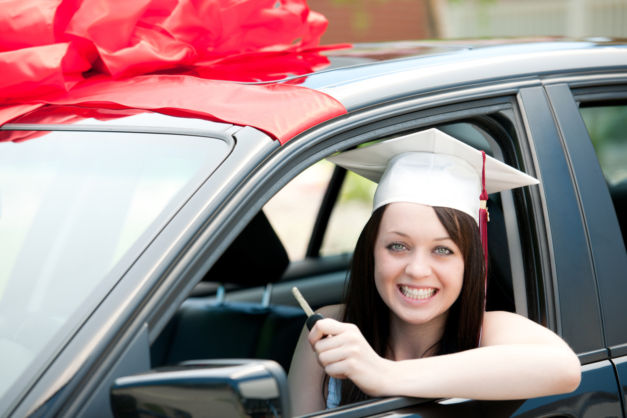 An international student reaching for the car key while sitting in a leased car.