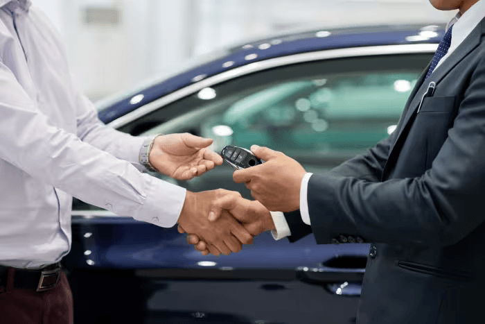 The car financing deal has been concluded. The buyer has received the car key.