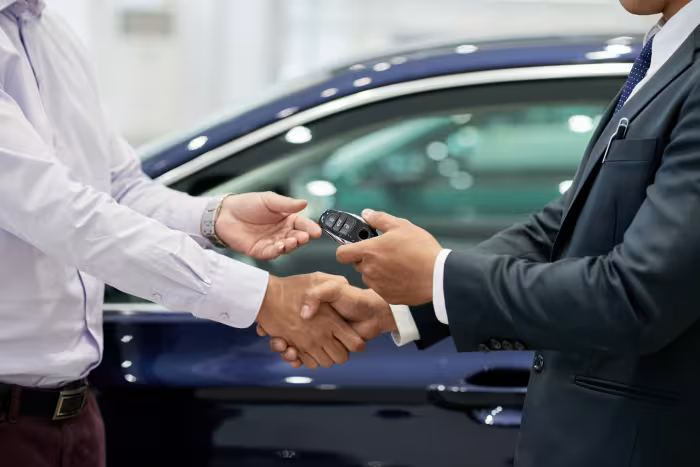 The car financing deal has been concluded. The buyer has received the car key.