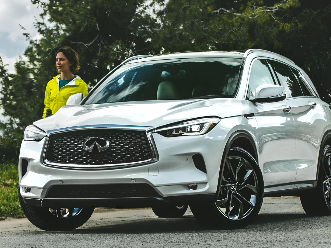 Woman stands near her newly leased car in Florida